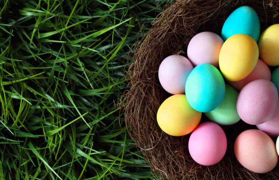 A basket of Easter eggs on grass