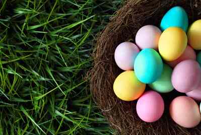 A basket of Easter eggs on grass