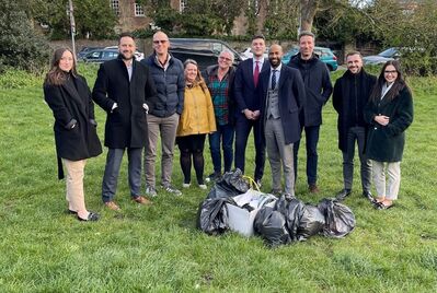 A group of people gathered around litter bags