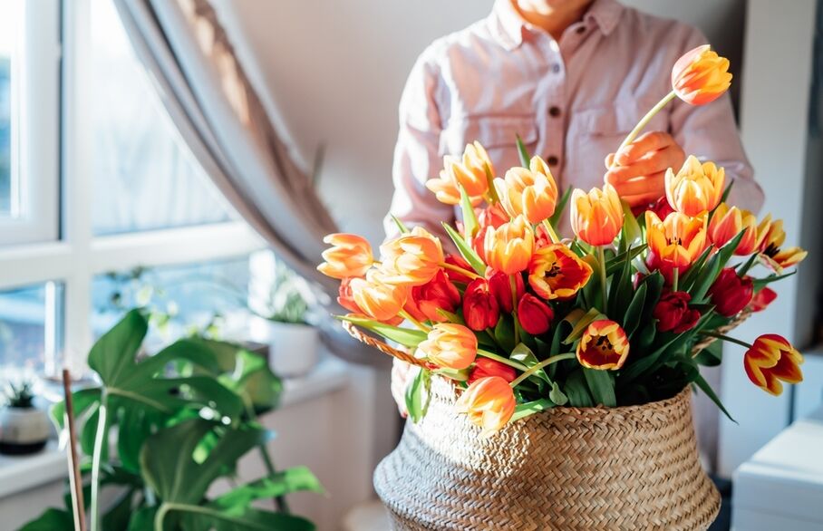 Someone arranging a bouquet of tulips