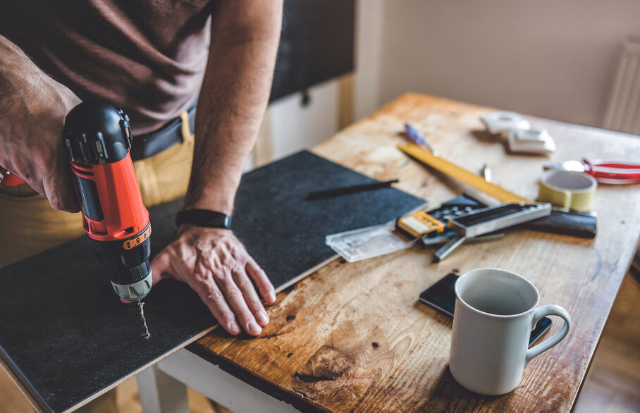 Someone drilling a piece of wood