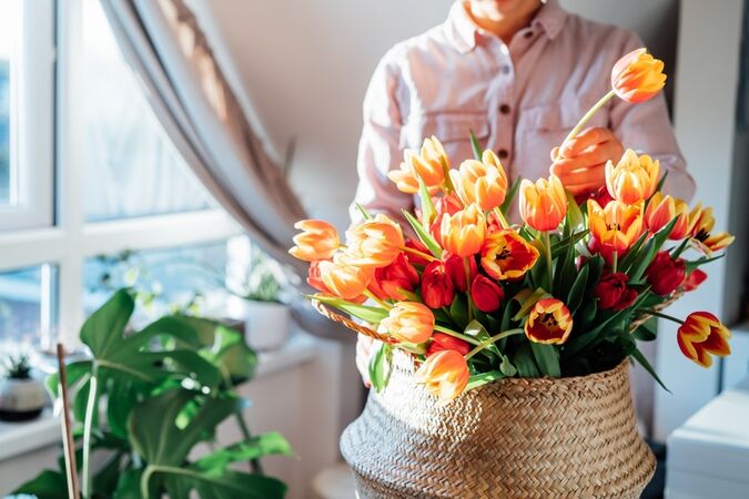 Someone arranging a bouquet of tulips