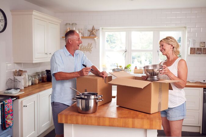 A couple packing-up kitchen