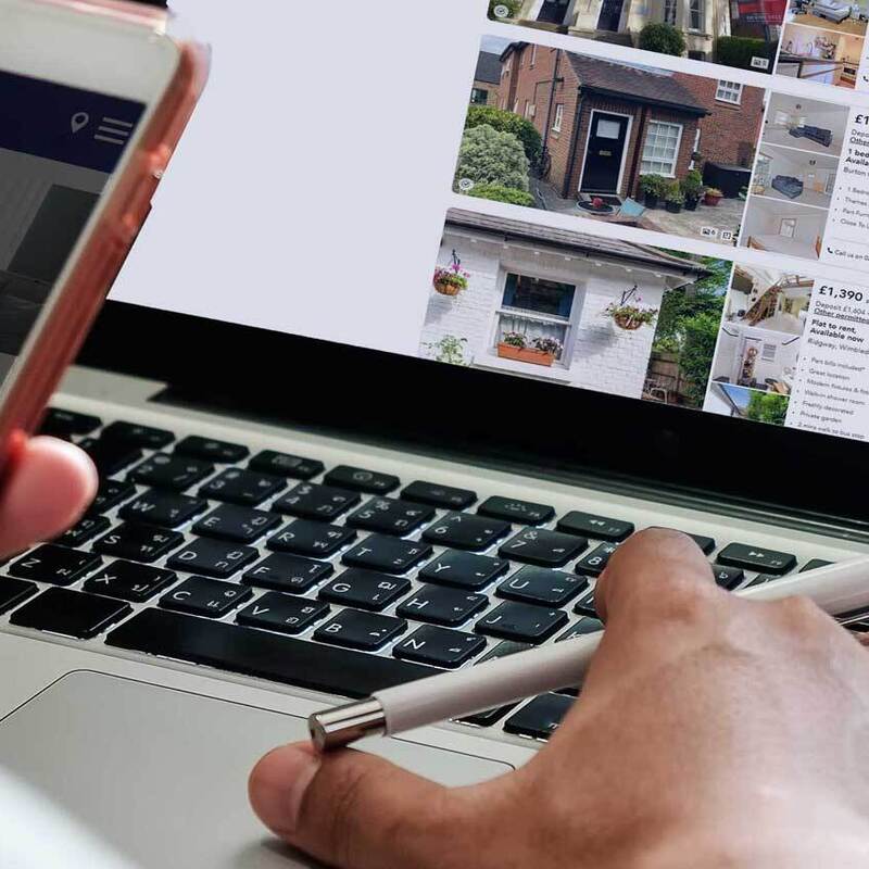 Checking properties on mbile with laptop open 