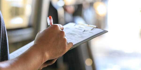 Property manager with clipboard, checking property