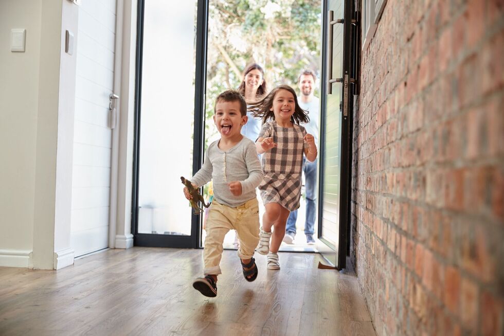 Happy children running into a new house