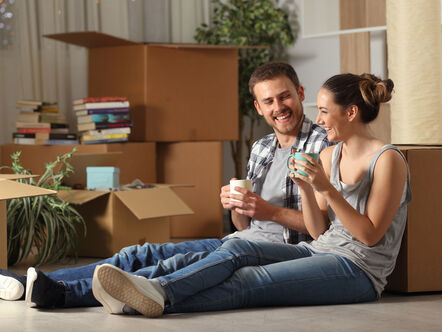 Couple sitting on floor after unpacking