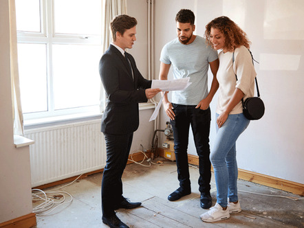 Couple Buying House For The First Time Looking At Survey