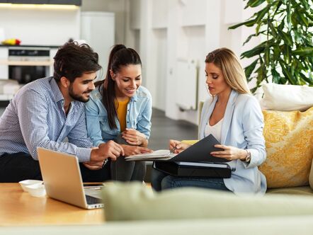 A couple talking to an estate agent