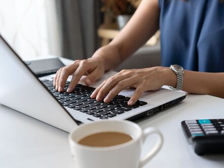 A person typing on a laptop