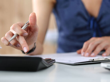 Close up of female making calculations.