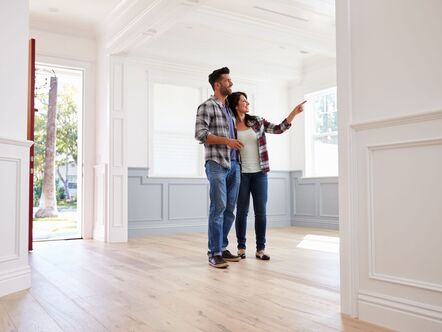 A couple looking around an empty house