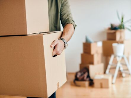 A person carrying a cardboard box